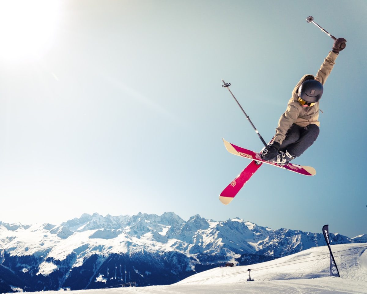 Snow-covered ski slopes and pine forest below rugged Rocky Mountain peaks at Breckenridge