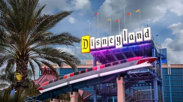 The Disneyland Hotel sign with a red monorail gliding past, colorful flags and a palm tree