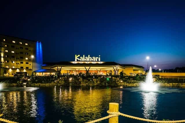 Kalahari Resort entrance glowing at dusk with fountains on the reflecting pool at Wisconsin Dells