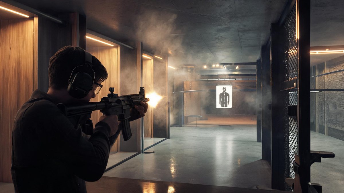 A visitor with ear protection firing a submachine gun inside an upscale modern indoor shooting lounge