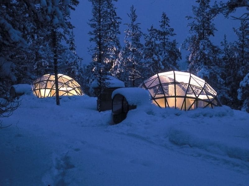 Transparent-domed igloo under the aurora at Borealis Basecamp